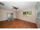 Spacious living room showcasing wood floors, a ceiling fan, and sliding glass doors to an outdoor area at 6530 68Th N St, Pinellas Park, FL 33781