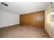 Living room featuring wood paneled accent wall and large window at 6530 68Th N St, Pinellas Park, FL 33781