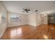 Inviting living room featuring gleaming wood floors, a ceiling fan, and natural light streaming through the windows at 6530 68Th N St, Pinellas Park, FL 33781