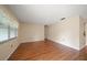Bright living room featuring wood floors, a large window, and neutral walls creating a welcoming space at 6530 68Th N St, Pinellas Park, FL 33781