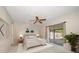 Serene main bedroom with soft lighting, ceiling fan, and sliding glass doors to the outdoors at 6530 68Th N St, Pinellas Park, FL 33781