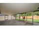 A covered patio extends the living space outdoors, featuring a view of the fenced backyard with lush greenery and meticulous landscaping at 6530 68Th N St, Pinellas Park, FL 33781