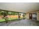 A covered patio with sliding doors overlooks a well-maintained lawn and wooden fence, providing a serene outdoor living space at 6530 68Th N St, Pinellas Park, FL 33781
