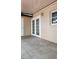 Exterior view of back patio with tiled flooring and sliding glass doors with window at 7107 Hernando Ct, Tampa, FL 33615