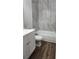 Bathroom features gray tiled walls, updated sink vanity, toilet, and bath tub at 7107 Hernando Ct, Tampa, FL 33615