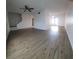 Spacious living room with updated flooring, staircase and double doors to the back patio at 7107 Hernando Ct, Tampa, FL 33615