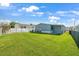 Spacious, well-maintained backyard with lush green grass and a white picket fence at 8443 Fantasia Park Way, Riverview, FL 33578