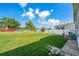 Large backyard with green grass, enclosed by a fence for added privacy and security at 8443 Fantasia Park Way, Riverview, FL 33578
