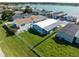 Aerial view featuring a well maintained backyard, complete with a chain-link fence, and lush green grass at 8443 Fantasia Park Way, Riverview, FL 33578