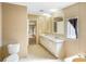 Bathroom featuring a dual sink vanity, window, and tile flooring at 8443 Fantasia Park Way, Riverview, FL 33578