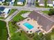 Aerial view of community pool, clubhouse, and recreational area by the lake at 8443 Fantasia Park Way, Riverview, FL 33578