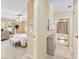 View into a Primary bedroom with an ensuite bathroom, neutral decor, and an exterior door nearby at 8443 Fantasia Park Way, Riverview, FL 33578