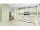 Functional kitchen featuring white appliances and plenty of counter space, bathed in natural light at 8443 Fantasia Park Way, Riverview, FL 33578