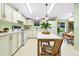 Bright eat-in kitchen features white cabinetry, appliances, and a dining area with lots of natural light at 8443 Fantasia Park Way, Riverview, FL 33578