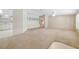 Spacious living area with plush carpeting, built-in storage, and an open layout at 8443 Fantasia Park Way, Riverview, FL 33578