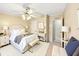 Bedroom featuring a ceiling fan, ensuite bath, and plenty of natural light at 8443 Fantasia Park Way, Riverview, FL 33578