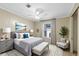 Bedroom with soft decor, large windows and calming ocean painting at 8443 Fantasia Park Way, Riverview, FL 33578