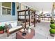 Inviting outdoor porch area, furnished with a comfortable couch and decorative plants at 8443 Fantasia Park Way, Riverview, FL 33578