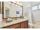 Bathroom with a granite countertop, wood cabinets, and decorated with neutral tones at 10203 Shadow Branch Dr, Tampa, FL 33647