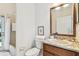 Well-lit bathroom with granite countertop and framed mirror at 10203 Shadow Branch Dr, Tampa, FL 33647