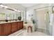 Bright bathroom featuring double vanity, soaking tub, and glass-enclosed shower at 10203 Shadow Branch Dr, Tampa, FL 33647