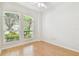 Bedroom with large windows overlooking well-manicured greenery at 10203 Shadow Branch Dr, Tampa, FL 33647