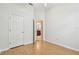 Bright bedroom with wood floors, white walls, and a door to the bathroom at 10203 Shadow Branch Dr, Tampa, FL 33647