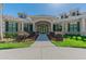 Beautiful clubhouse entrance featuring manicured landscaping and elegant architectural design at 10203 Shadow Branch Dr, Tampa, FL 33647