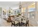 Bright dining area with pendant lighting, plantation shutters, and seating for four at 10203 Shadow Branch Dr, Tampa, FL 33647