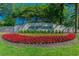 Community entrance sign amidst colorful flowers and lush landscaping at 10203 Shadow Branch Dr, Tampa, FL 33647