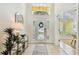 Bright and inviting foyer with tile flooring, a decorative front door, and high ceilings at 10203 Shadow Branch Dr, Tampa, FL 33647