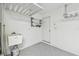 Garage interior showing door to house, with speckled epoxy flooring at 10203 Shadow Branch Dr, Tampa, FL 33647