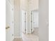 Hallway with tile flooring and multiple doorways at 10203 Shadow Branch Dr, Tampa, FL 33647