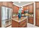 Modern kitchen with stainless steel appliances, central island, and dark wood cabinetry at 10203 Shadow Branch Dr, Tampa, FL 33647