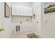 Laundry room featuring tile flooring, white cabinets, and utility connections at 10203 Shadow Branch Dr, Tampa, FL 33647