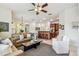 Open-concept living room with ceiling fan, breakfast bar and view to kitchen at 10203 Shadow Branch Dr, Tampa, FL 33647