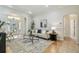 Bright living room featuring a stylish rug, neutral sofa, and elegant decor at 10203 Shadow Branch Dr, Tampa, FL 33647
