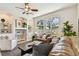 Bright living room featuring built-in shelving, a ceiling fan, and natural light at 10203 Shadow Branch Dr, Tampa, FL 33647
