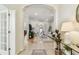 Open-concept living room with tile flooring, neutral decor, and an arched doorway to another room at 10203 Shadow Branch Dr, Tampa, FL 33647
