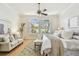 Bright main bedroom with light walls, hardwood floors, ceiling fan and natural light at 10203 Shadow Branch Dr, Tampa, FL 33647