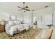 Bright main bedroom with light walls, hardwood floors, ceiling fan and access to en-suite at 10203 Shadow Branch Dr, Tampa, FL 33647