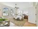 Spacious main bedroom with light walls, hardwood floors, ceiling fan and natural light at 10203 Shadow Branch Dr, Tampa, FL 33647