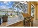 Stainless steel grill and prep area next to a screened pool and patio area at 10203 Shadow Branch Dr, Tampa, FL 33647
