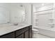 The bathroom features a single sink vanity, quartz countertop, and shower-tub combo at 10426 Cross River Trl, Parrish, FL 34219