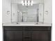 Bright bathroom features a double sink vanity, quartz countertops, and a large mirror at 10426 Cross River Trl, Parrish, FL 34219