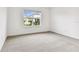 Clean and bright bedroom with a large window, neutral carpet, and ample space at 10426 Cross River Trl, Parrish, FL 34219