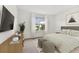 Inviting bedroom with neutral decor, a large window, and comfortable furnishings at 10426 Cross River Trl, Parrish, FL 34219