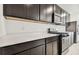 Stylish kitchen featuring dark cabinets, stainless steel appliances, and sleek countertops at 10426 Cross River Trl, Parrish, FL 34219