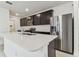 Well-equipped kitchen with stainless steel appliances, dark cabinetry, and a spacious center island at 10426 Cross River Trl, Parrish, FL 34219