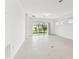 Bright, open living space with tile floors and sliding glass doors leading to the backyard at 10426 Cross River Trl, Parrish, FL 34219
